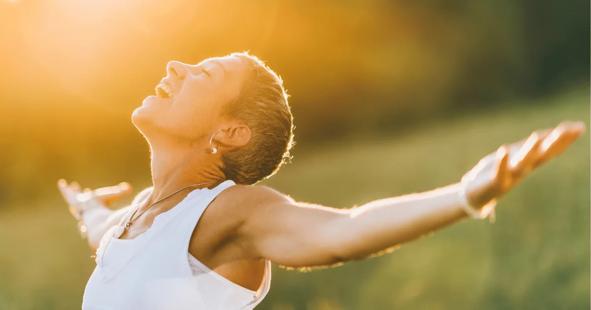 A woman in the open out on the fields with a simile